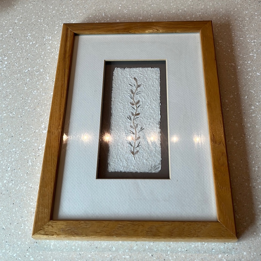 Picture. Design made of paper and flower stems.
